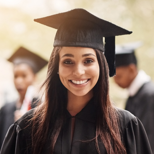 A photographic style image of a recent graduate at her post-secondary graduation ceremony.